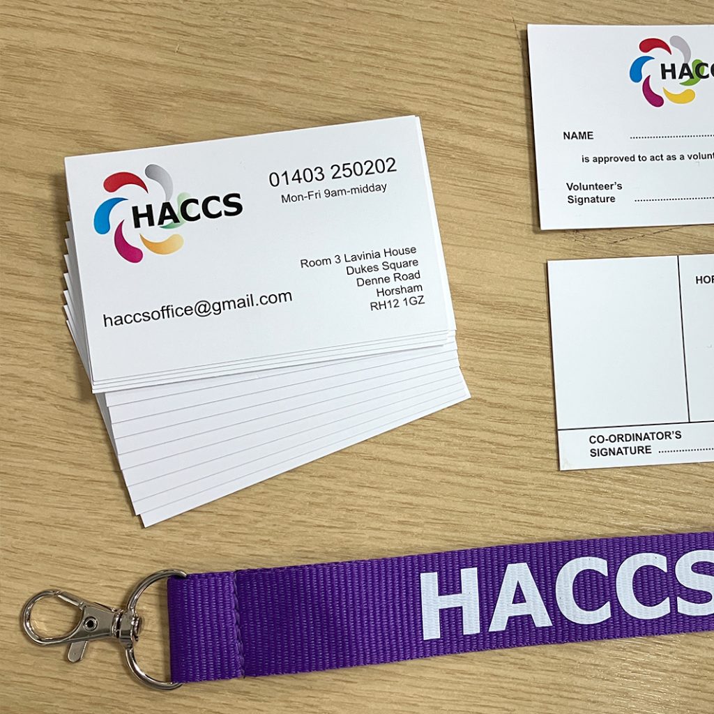 bold purple lanyards featuring large white HACCS 